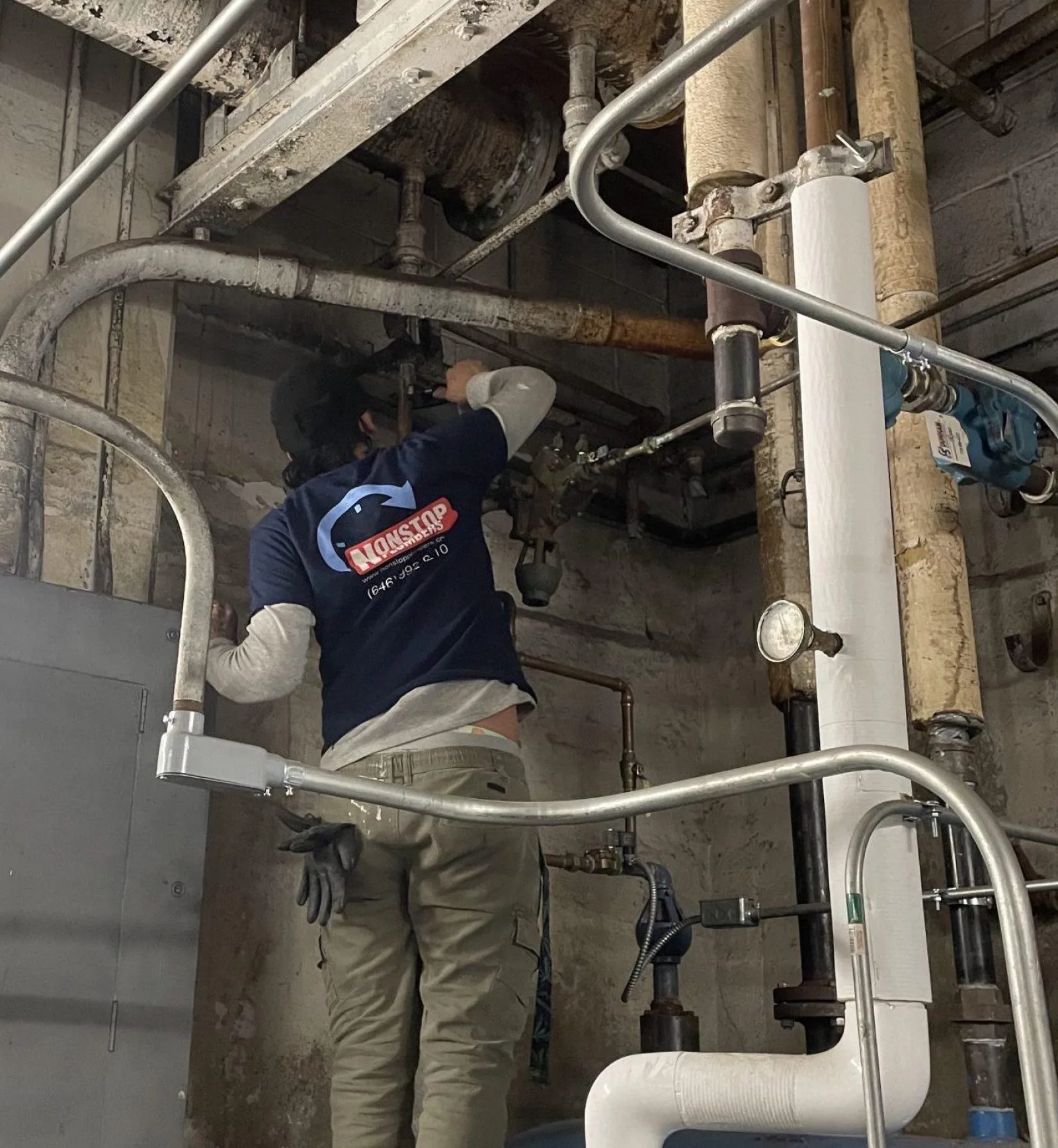 Nonstop Plumbers NY technician working on piping in a mechanical room.