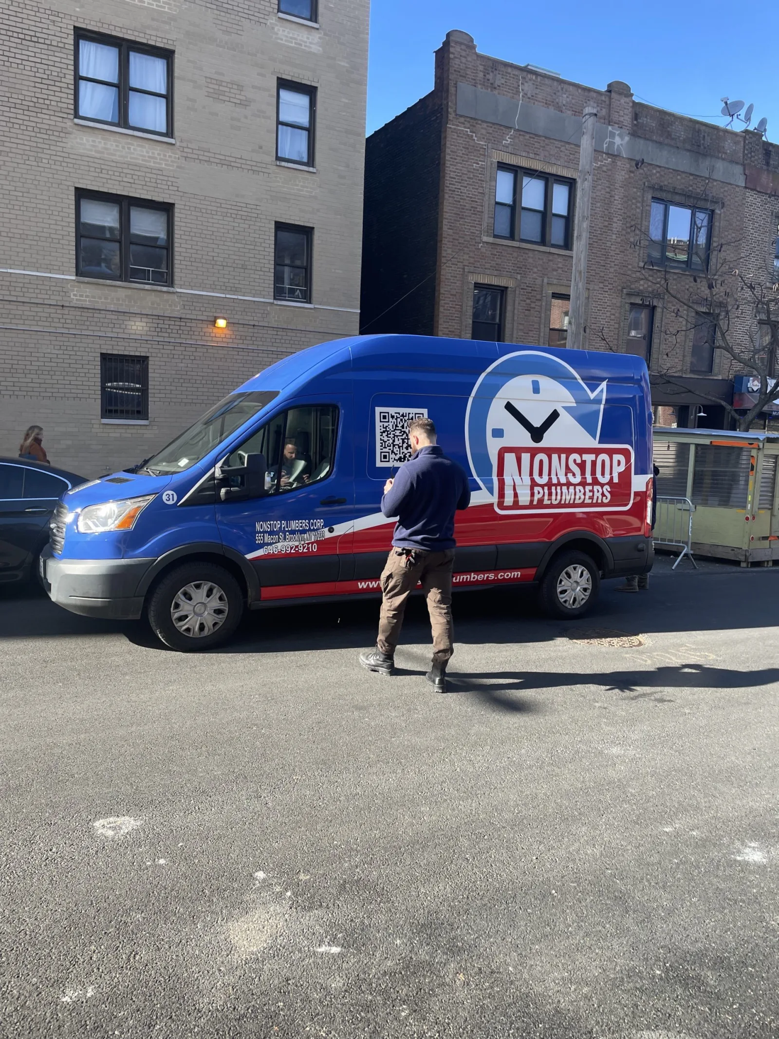 Nonstop Plumbers NY service van parked on a New York City street.